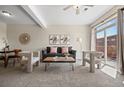 Inviting living room featuring neutral tones, modern furniture, and a sliding door to a private balcony at 7883 W 55Th Ave, Arvada, CO 80002