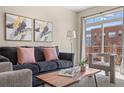 Comfortable living room with modern furniture, stylish decor, and sliding glass doors to balcony at 7883 W 55Th Ave, Arvada, CO 80002