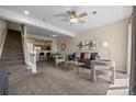 Spacious living room with stairs, open layout to dining area and contemporary furnishings at 7883 W 55Th Ave, Arvada, CO 80002