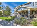 Inviting front porch with stone pillars, seating, and manicured landscaping at 1133 S Richfield St, Aurora, CO 80017