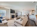 Bright living room with fireplace, neutral decor, and open layout at 1133 S Richfield St, Aurora, CO 80017