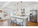Beautiful kitchen features modern lighting, stainless appliances, and a large center island at 2801 Cherry St, Denver, CO 80207