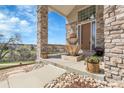 Inviting front porch with stone columns and decorative water fountain at 23965 E Kettle Pl, Aurora, CO 80016