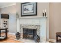 Cozy fireplace with a decorative mantel and mosaic tile surround at 824 S Medea Way, Denver, CO 80209