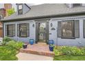 Inviting front entrance with brick steps and a classic blue painted brick exterior at 824 S Medea Way, Denver, CO 80209