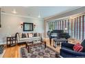 Elegant living room featuring a bay window, hardwood floors, and stylish decor at 824 S Medea Way, Denver, CO 80209
