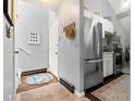 Inviting entryway with neutral walls, coat rack, and bright, patterned area rug at 4070 S Atchison Way # 304, Aurora, CO 80014