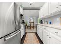 Bright kitchen with white cabinets, stainless steel appliances, and view into the dining area at 4070 S Atchison Way # 304, Aurora, CO 80014