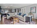 Open-concept living room with a large sofa, and views into the kitchen at 704 N Pearl St # 0-323, Denver, CO 80203