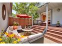 Comfortable outdoor living space with plush seating, a grill and shade from mature tree at 5161 S Emporia Way, Greenwood Village, CO 80111