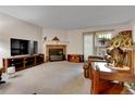 Living room with fireplace, TV, and comfortable seating at 1695 Carr St # B, Lakewood, CO 80214