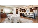 Spacious eat-in kitchen with stainless steel appliances, dark wood cabinets, and counter seating at 57 Mc Intyre Cir, Golden, CO 80401