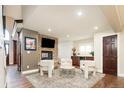 Cozy living room featuring a stone fireplace, modern seating, and hardwood floors at 57 Mc Intyre Cir, Golden, CO 80401