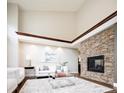 Bright living room featuring a stone fireplace, vaulted ceilings, and modern white furniture at 57 Mc Intyre Cir, Golden, CO 80401