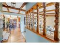 Home foyer featuring wood floors and exposed wood beams on the ceiling and an adjacent dining area at 7290 Lamar Ct, Arvada, CO 80003
