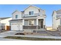 Two-story house with gray siding, white trim, and a two-car garage at 1322 Bloom St, Brighton, CO 80601