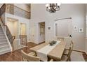 Open-concept dining area with staircase, chandelier, and ample natural light, showcasing a Gathering-friendly layout at 4542 Valleybrook Dr, Highlands Ranch, CO 80130