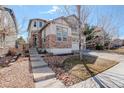 Charming two-story home featuring stone and stucco accents, a well-manicured lawn, and inviting curb appeal at 4542 Valleybrook Dr, Highlands Ranch, CO 80130