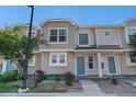 Charming multi-level townhouse showcasing neutral siding, beautiful landscaping, and an inviting blue front door at 18954 E 57Th Pl # D, Denver, CO 80249