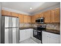 Well-appointed kitchen features stainless steel appliances, stylish countertops, and updated cabinetry at 18954 E 57Th Pl # D, Denver, CO 80249