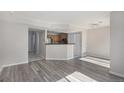 Bright living room features open access to the kitchen, creating an inviting space for gathering and entertaining at 18954 E 57Th Pl # D, Denver, CO 80249