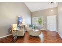 Bright living room with hardwood floors, vaulted ceiling, and stylish furnishings at 20293 E Progress Pl, Centennial, CO 80015