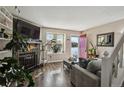 Cozy living room featuring a charming fireplace, bright windows, and a stylishly decorated space at 5415 S Delaware St, Littleton, CO 80120