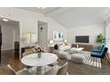 Bright living room features vaulted ceilings, modern décor, and wood flooring at 2565 Gray St, Edgewater, CO 80214
