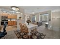 Inviting dining area with a floral centerpiece, seamlessly flowing into the kitchen and living room at 479 Black Feather Loop # 311, Castle Rock, CO 80104