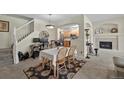 Cozy dining area showcasing a fireplace, open staircase and seamless flow to a well-lit kitchen at 479 Black Feather Loop # 311, Castle Rock, CO 80104