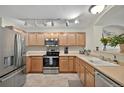 Well-lit kitchen featuring stainless steel appliances, ample cabinet space, and sleek countertops at 479 Black Feather Loop # 311, Castle Rock, CO 80104