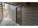 View of the apartment entrance, showcasing the door numbered 101 with wood siding at 2575 S Syracuse Way # B101, Denver, CO 80231