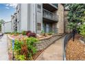 Exterior of the building with garden beds, rock landscaping, and handicap parking space at 2575 S Syracuse Way # B101, Denver, CO 80231