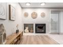 Cozy living room with fireplace and decorative wall accents, illuminated by recessed lighting at 2575 S Syracuse Way # B101, Denver, CO 80231