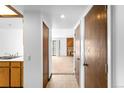 Hallway view showing access to the kitchen and the living area with a stone fireplace at 4896 S Dudley St # 6-5, Littleton, CO 80123