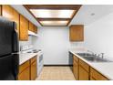 Functional kitchen featuring light wood cabinets, essential appliances, and ample counter space at 4896 S Dudley St # 6-5, Littleton, CO 80123