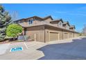 Townhome garages and handicap parking. Garage doors match siding at 6406 Silver Mesa Dr # F, Highlands Ranch, CO 80130