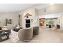 Staged living room with neutral tones, plush seating, and adjacent dining area showcasing the space at 930 Reed Ct, Lakewood, CO 80214