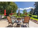 Inviting outdoor patio area with a fire pit, comfortable seating, and a beautiful view of the surrounding landscape at 930 Reed Ct, Lakewood, CO 80214