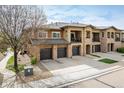 Modern townhouse showcasing stone accents, private balconies, and attached garages at 1122 Olympia Ave # 12H, Longmont, CO 80504