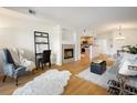 Open-concept living room with a fireplace and view into the kitchen and dining area at 1122 Olympia Ave # 12H, Longmont, CO 80504