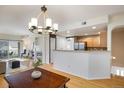 Bright open-concept living room and kitchen with hardwood floors and fireplace at 1122 Olympia Ave # 12H, Longmont, CO 80504