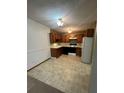 Kitchen features classic wood cabinets, black appliances, and plenty of space at 750 S Alton Way # 8C, Denver, CO 80247