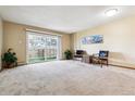 Bright, carpeted living room with sliding glass doors to a balcony at 750 S Alton Way # 8C, Denver, CO 80247
