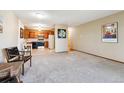 View of open concept living space featuring kitchen and carpeted living room at 750 S Alton Way # 8C, Denver, CO 80247