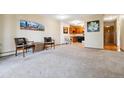 Open-concept living space adjoining kitchen with carpeted flooring at 750 S Alton Way # 8C, Denver, CO 80247