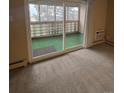 A sliding door opens to a patio with privacy elements at 750 S Alton Way # 8C, Denver, CO 80247