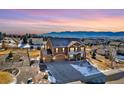 Beautiful aerial view of a spacious home with mountain views and fenced yard at 1235 Woodmoor Acres Dr, Monument, CO 80132