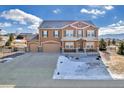 Two-story house with a three-car garage and a partially snow-covered front yard at 1235 Woodmoor Acres Dr, Monument, CO 80132