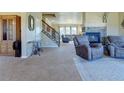 Spacious living room with a stone fireplace and comfortable seating at 1235 Woodmoor Acres Dr, Monument, CO 80132